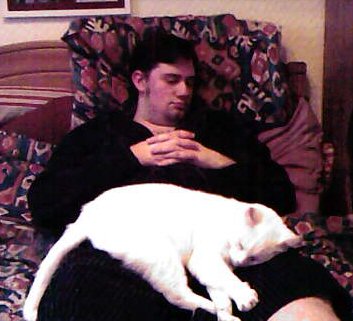 Snowy sleeping on a snoozing Sean.